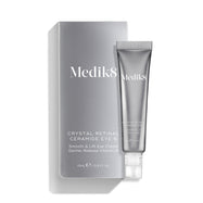  Na obrázku je stříbrná tuba přípravku Crystal Retinal Ceramide Eye 6 vedle odpovídajícího stříbrného kartonového obalu.