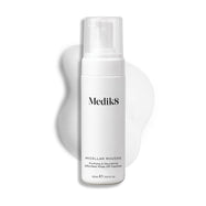 Pumpičková lahvička Medik8 Micellar Mousse zobrazená na bílém pozadí s rozmazanou stopou bílé pěny za ní, která zvýrazňuje texturu produktu.