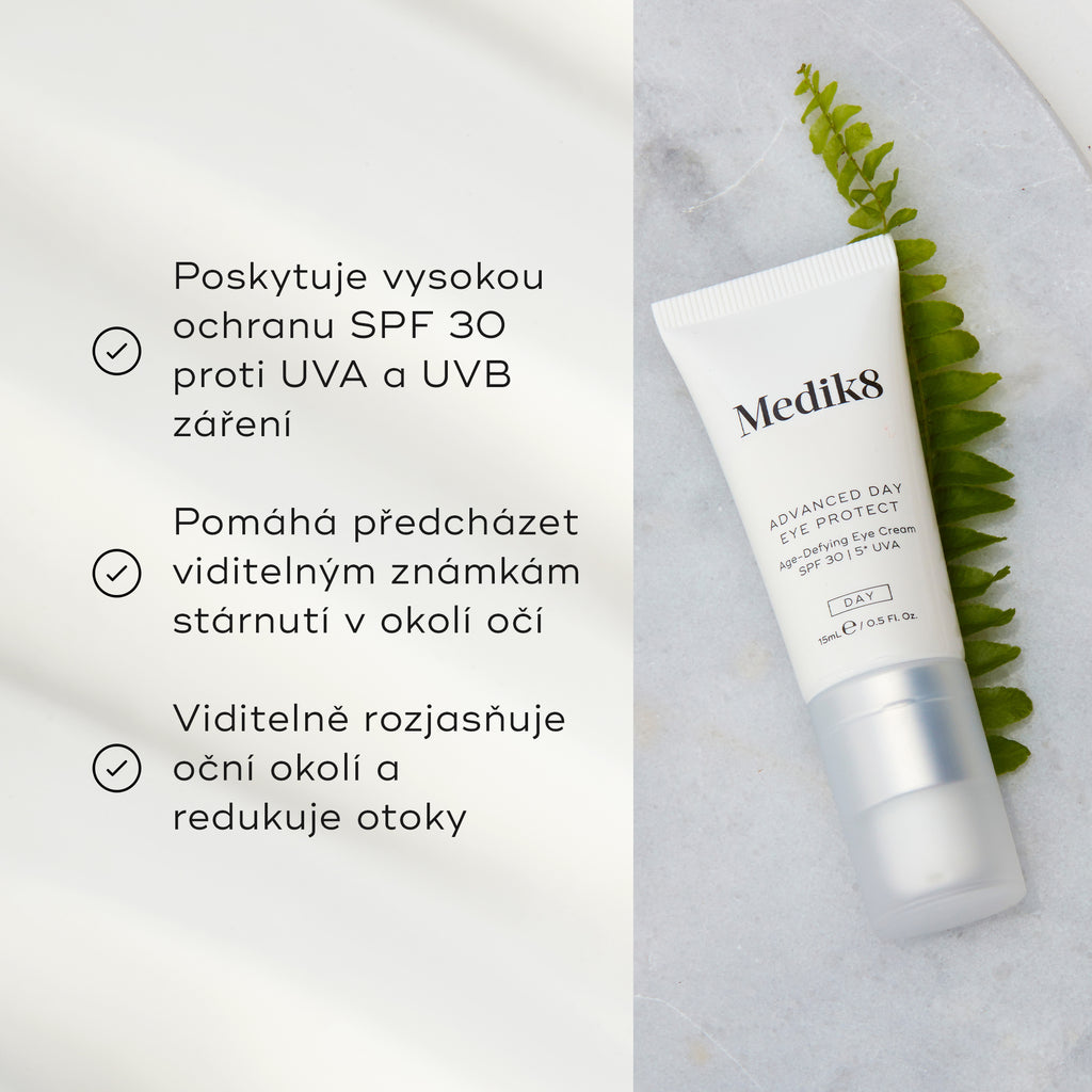 Tuba Advanced Day Eye Protect leží na mramorovém povrchu vedle zeleného listu kapradiny. Text zdůrazňuje její ochranu SPF 30, prevenci viditelných známek stárnutí a schopnost rozjasnit a redukovat otoky v očním okolí.