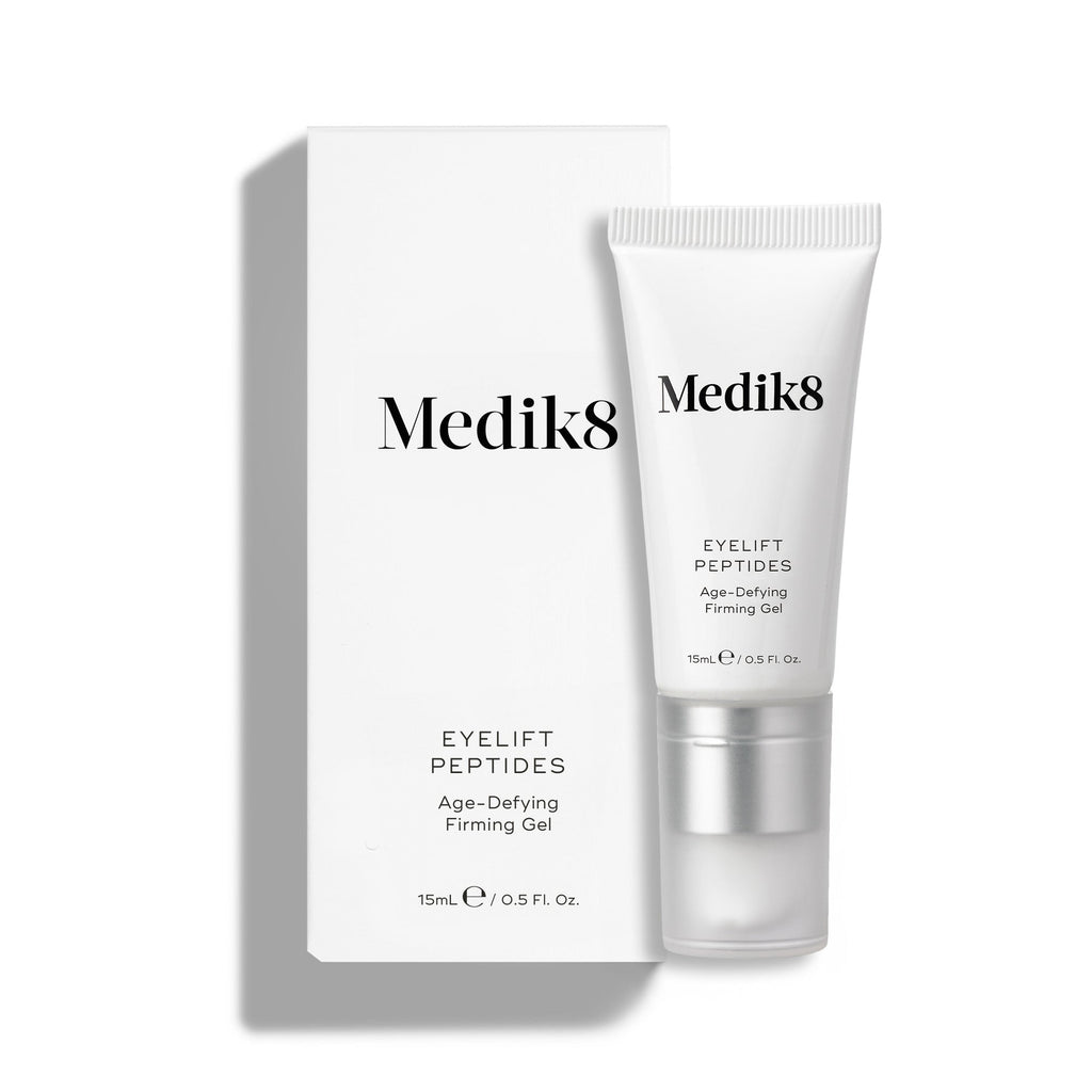 Bílá tuba Eyelift Peptides je zobrazena stojící vedle své odpovídající bílé krabičky.